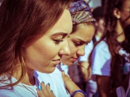Young girls with their hand on their hearts during the singing of the National Anthem