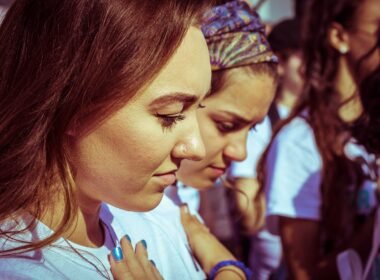 Young girls with their hand on their hearts during the singing of the National Anthem